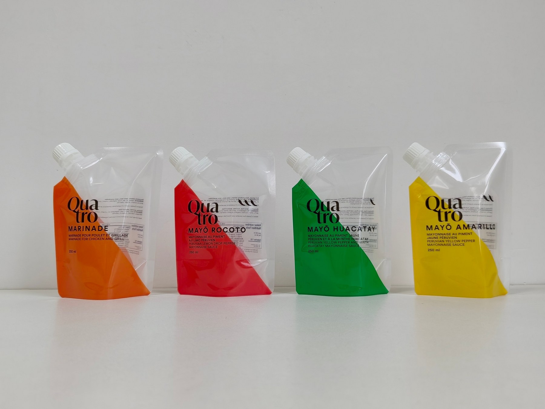 Four printed Quatro spout pouches produced by SF Packaging